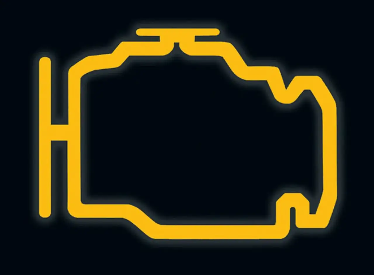 Żółty symbol silnika na ciemnym tle, ostrzegający o awarii. Check engine BMW – czas na wizytę w serwisie.